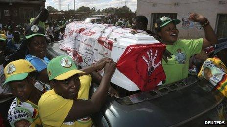 Supporters of ZANU-PF party celebrate with a coffin wrapped in a Movement for Democratic Change (MDC) flag in Mbare township, outside Harare