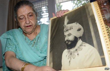 Amrit Kaur, the daughter of the late Maharaja of Faridkot- Harinder Singh Brar, poses with a portrait of the Maharaja at her residence in Chandigarh on August 2, 2013