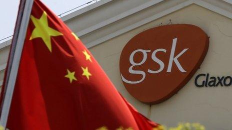 A Chinese flag is hoisted in front of the GlaxoSmithKline building in Shanghai, China, 24 July 2013