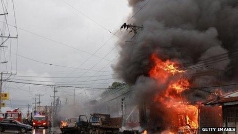 Emergency teams attend the scene following a powerful car bomb explosion