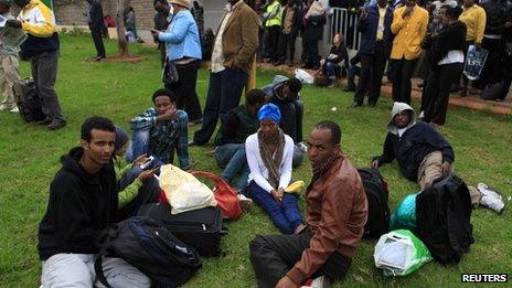 Stranded passengers and onlookers gather after a fire disrupted all operations at the Jomo Kenyatta International Airport in Kenya's capital Nairobi on Wednesday