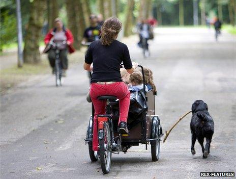 Woman with children in cargo bike