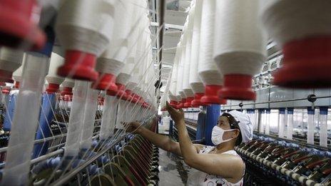 A labourer is seen working in a textile factory in Huaibei, in north China's Anhui province