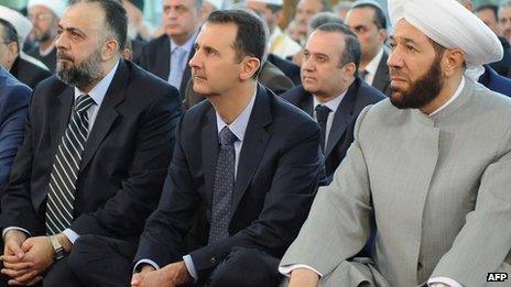 A handout picture released by the Syrian Arab News Agency (SANA) on 8 August, 2013 shows Syrian President Bashar al-Assad (C) and Syrian Grand Mufti Ahmed Hassun (R) attending the Eid al-Fitr morning prayer in Damascus.