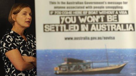 Australia's Acting High Commissioner to Sri Lanka Sonya Koppe looks on behind a banner on new measures to curb Sri Lankans illegally entering Australia at a press conference in Colombo on 26 July 2013