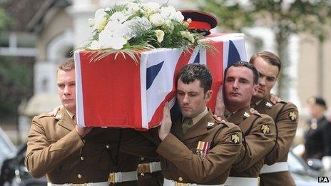 The coffin of Lance Corporal Craig Roberts is carried into the Holy Trinity Church, Llandudno for his funeral