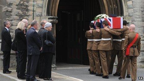 Mourners watch as the coffin of Lance Corporal Craig Roberts is carried into the Holy Trinity Church, Llandudno for his funeral