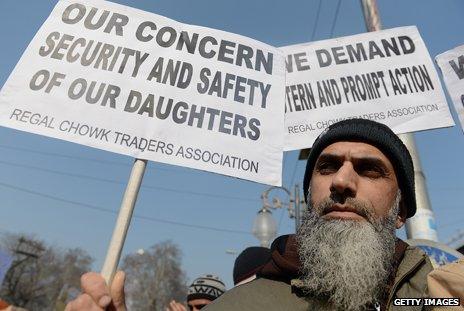 A Kashmiri man hold a protest placard saying: "Our concern - security and safety of our daughters"