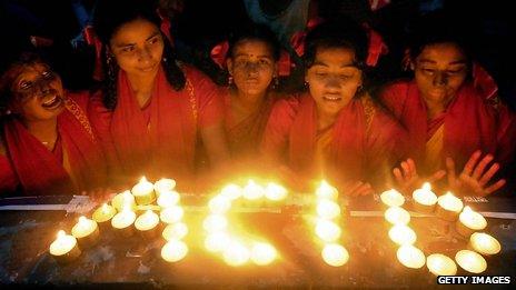 Young Bangladeshi acid attack victims use candles to write the word "Acid"