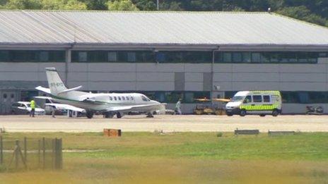 Plane on runway at Northolt with ambulance approaching