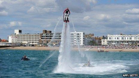 A man entertains crowds with a water jet pack at Worthing Birdman