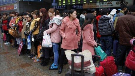 Migrant workers make their way to Shanghai railway station, the meeting point where an online employment agency arranged to pick them up to their new jobs, in Shanghai in this February 26, 2013 file photo.