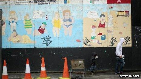 A man walks past a derelict building on Rhyl Promenade in Rhyl