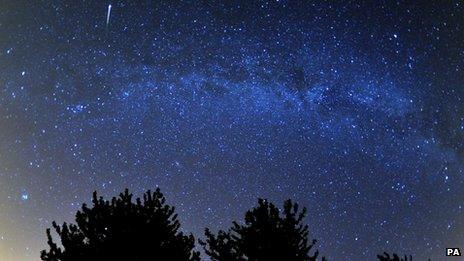 A meteor is seen during the Perseids meteor shower over the Cotswold Water Park near Cirencester, Gloucestershire