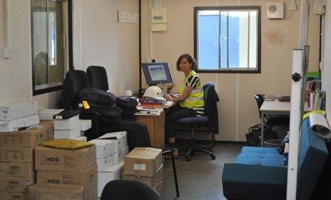 Head teacher sits at a desk in her on-site office