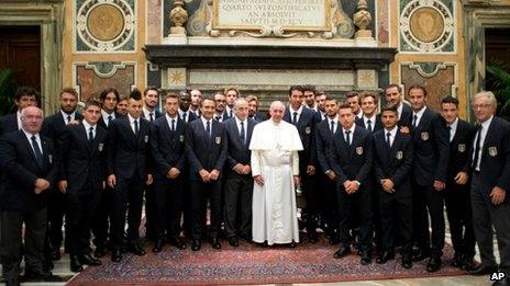 Pope Francis poses with the Italian national soccer team, at the Vatican, Tuesday, 13 August, 2013