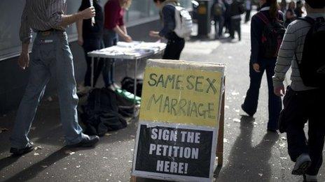 A signboard urging support of gay marriage attracts passersby in downtown Sydney