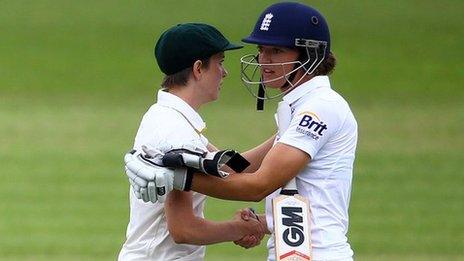 England and Australia women's cricketers shake hands on a draw