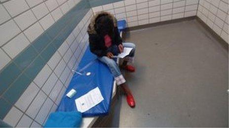 A woman in a police cell