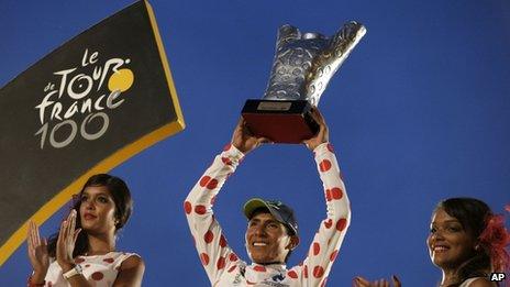 Nairo Quintana wearing the best climber's dotted jersey celebrates on the podium of the 100th edition of the Tour de France on 21 July, 2013.