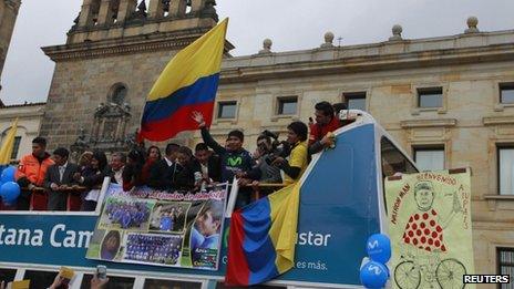 Nairo Quintana waves from an open top bus in Bogota on 13 August 2013