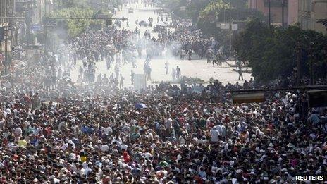 Supporters of ousted Egyptian President Mohammed Morsi run away from tear gas during clashes in Cairo 16 August, 2013.