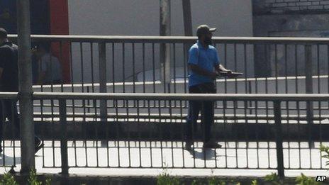 A man is seen firing a weapon in the direction of security forces in Cairo (16 August, 2013).