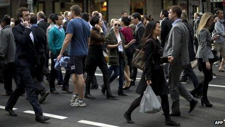 Pedestrians cross an intersection Sydney on June 13, 2013