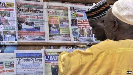 People look at newspapers on display at a newsstand on 12 August 2013 in Bamako, Mali