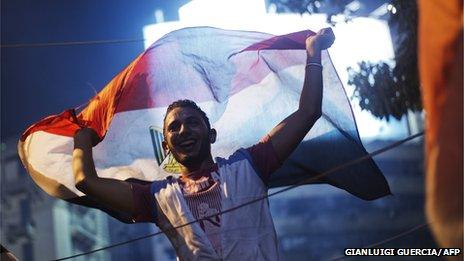 People celebrate at Tahrir Square after a broadcast confirming that the army will temporarily be taking over from the country"s first democratically elected president Mohammed Morsi on (3 July 2013)