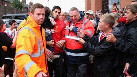 Liverpool striker Luis Suarez is mobbed by the club's fans at Anfield