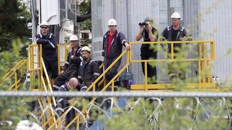 Workers gather at the drilling site