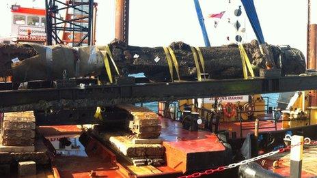 Swash Channel Wreck rudder being raised with the image of a man's face