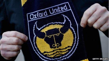 Oxford United supporter proudly displays his club scarf