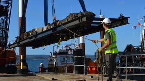 Swash wreck rudder being brought ashore