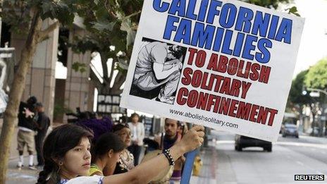 Karen Cuauhtemoc holds a sign during a rally supporting hunger strikers in the California prison system in Los Angeles, California on 29 July 2013