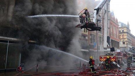 Fire fighters tackle the blaze at Paul's Hair World on Saturday
