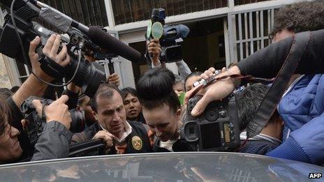 Michaella McCollum being escorted out of the public prosecutor's office in Callao, Peru, on 20 August 2013 to be taken to the district court