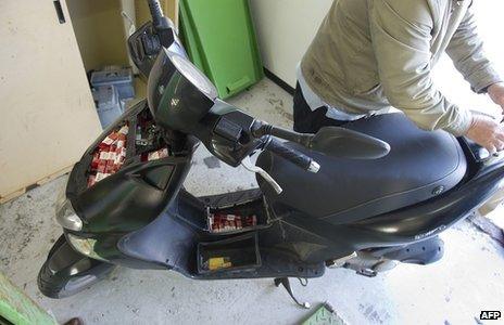 Contraband packs of cigarettes in a motorcycle after it was seized by the Guardia Civil at the border between Spain and Gibraltar. (file photo)