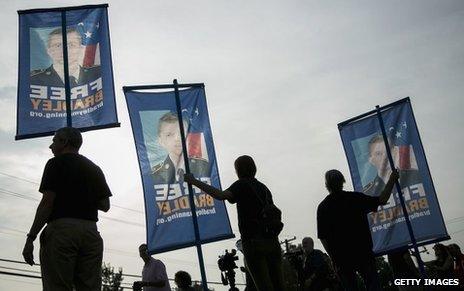 Supporters with "Free Bradley" banners outside the hearing, 21 August 2013