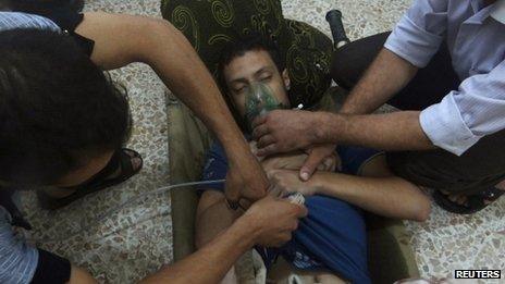 A man, affected by what activists say is nerve gas, breathes through an oxygen mask in the Damascus suburbs of Jesreen August 21, 2013