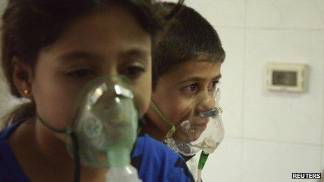 Children, affected by what activists say was a gas attack, breathe through oxygen masks in the Damascus suburb of Saqba on 21 August 2013