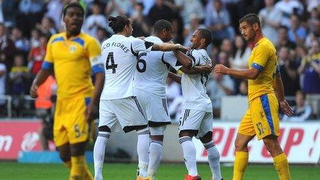 Swansea player Wayne Routledge (r) celebrates with team mates