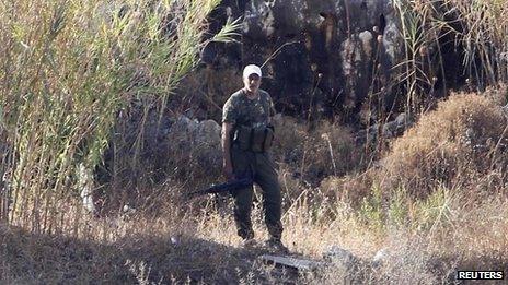 PFLP member stands near site where group says Israeli rockets hit, in Naameh, Lebanon, on 23 August 2013