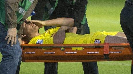 Andreas Cornelius of Cardiff City is carried off on a stretcher
