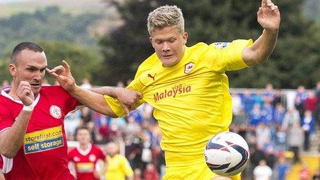 Tom Aldred of Accrington Stanley, left, challenges Andreas Cornelius of Cardiff City