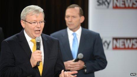 Australia's Prime Minister Kevin Rudd (L) speaks as opposition leader Tony Abbott (R) listens during a people's forum in Brisbane on 21 August 2013