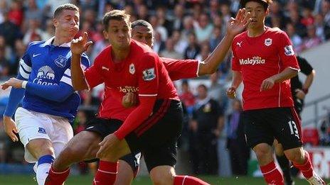 Everton’s Ross Barkley shoots past Cardiff’s Ben Turner and Steven Caulker