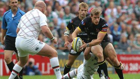 Andrew Trimble tries to break away from a Tom Croft tackle as Dan Cole looms for the Ulster winger