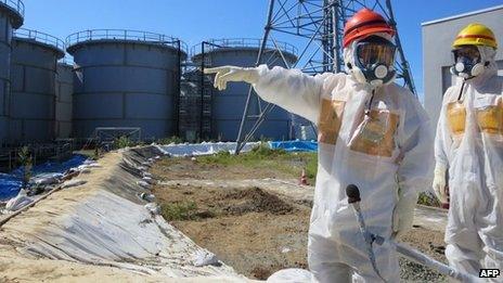 Japanese Economy, Trade and Industry Minister Toshimitsu Motegi (2nd R-red helmet) inspecting contamination water tanks